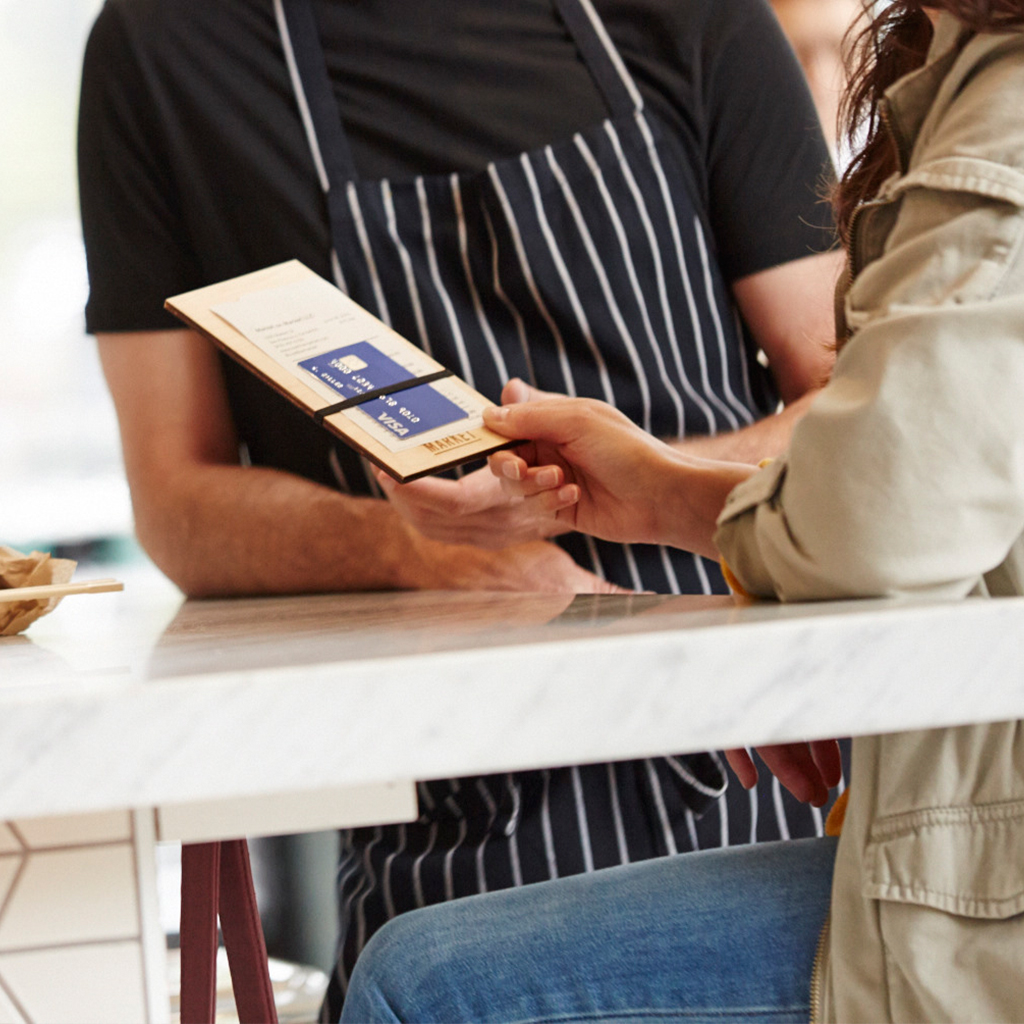 Handing the waiter the Visa card