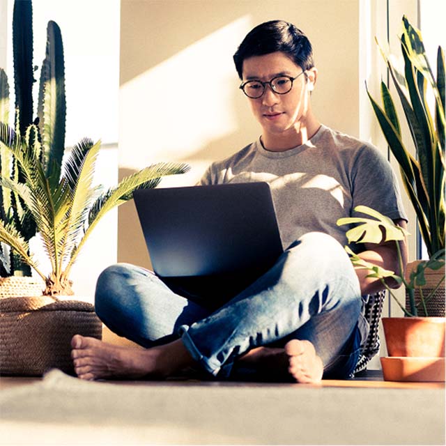 man on floor cross legged with laptop