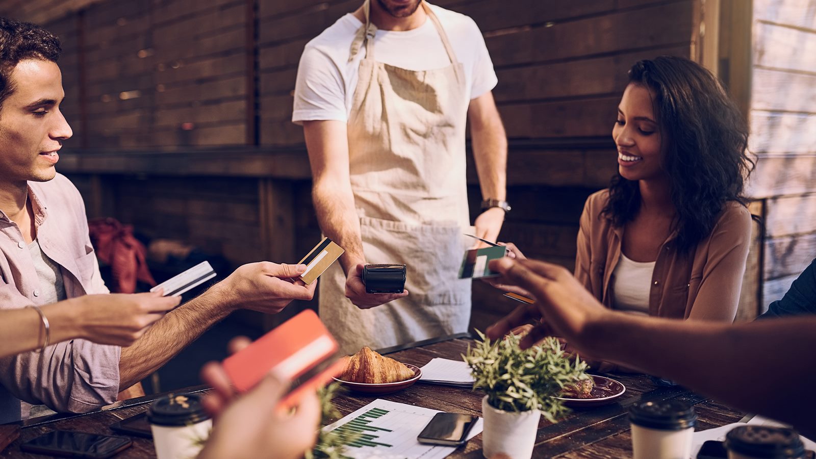 people paying contactless around the table